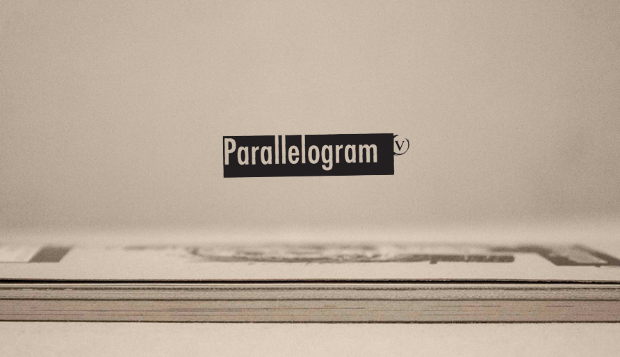 Side shot of Roberto Millan's Parallelogram comics anthology publication for the Vega School Showcase with the black Parallelogram logo in the negative space above the book with a brown paper background.